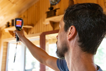Indoor damp & air quality (IAQ) testing. A closeup view of an air specialist inspecting the...