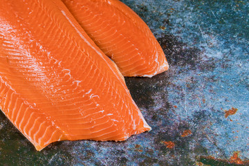 Fresh raw salmon red fish with dark background flat lay