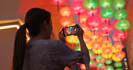 Woman take photo with cellphone on the chinese lantern © leungchopan