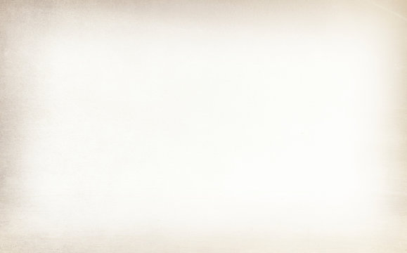 Old vintage paper with a glowing center and grunge vignette.