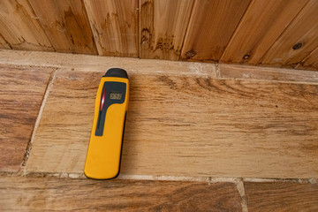 Indoor damp & air quality (IAQ) testing. A timber moisture detector is seen close up with...
