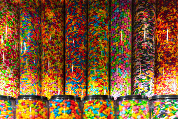 Colorful candies in jars as background