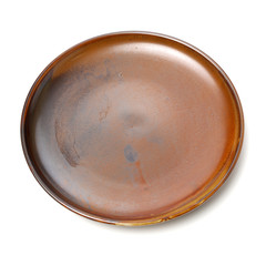Empty brown earthenware plate on white background