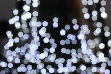 Beautiful blurry image of bokeh light on street during festival such as Christmas, New Year. De focus at colorful light bulbs.