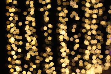 Beautiful blurry image of bokeh light on street during festival such as Christmas, New Year. De focus at colorful light bulbs.