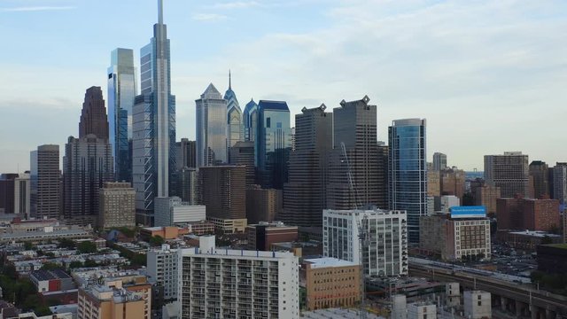 Aerial Drone Flying Left And Backward Through Philadelphia City Skyline Showcasing Comcast Technology Center And Tall East Coast Skyscrapers And Buildings