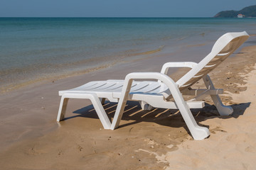 Fototapeta na wymiar Beach chair at sunny coast at the beach