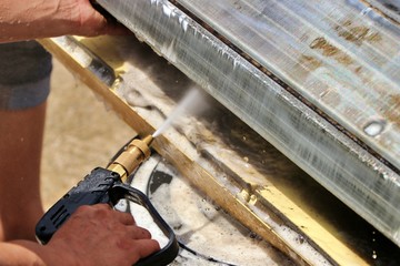 Wash away foam from air conditioner with high pressure water sprayer. Air conditioner maintenance,...