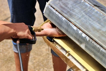 Wash away foam from air conditioner with high pressure water sprayer. Air conditioner maintenance,...