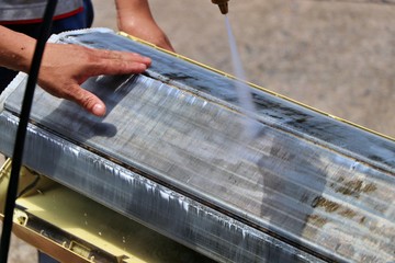 Wash away foam from air conditioner with high pressure water sprayer. Air conditioner maintenance,...