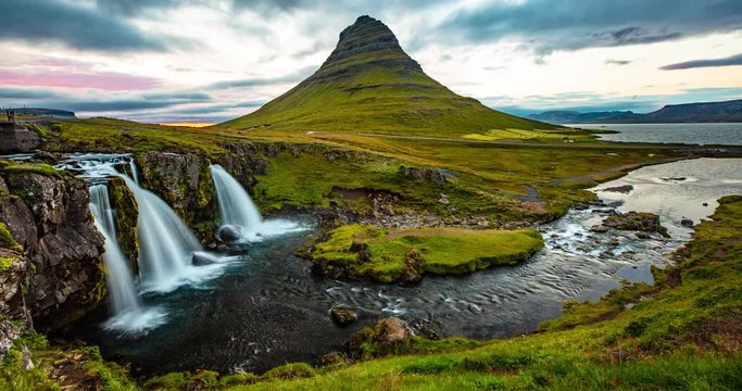 Iceland timelapse photography of waterfall and famous mountain. Kirkjufellsfoss and Kirkjufell in northern Iceland nature landscape. Time lapse video in 4K.