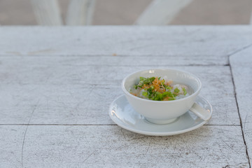 Boiled rice with pork in white bowl