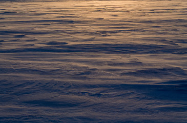 Dawn on the frozen lake. Strong wind and Blizzard. Low freezing temperature.