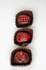 cherry, grape, strawberry chocolate on white background