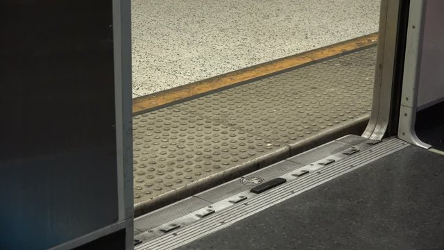 People exiting a subway and the doors closing