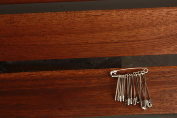 sewing pin on wooden background