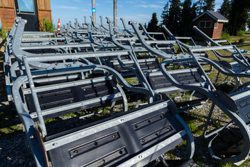 Out of service chairlift chairs at the base of Seymour Mountain.