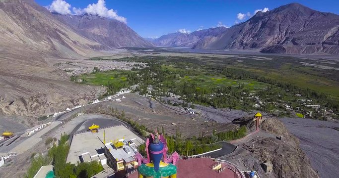 Drone shot from the back of Maitreya buddha to Nubra valley.//Drone shot