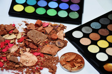 Eye shadow colorful shattered into powder. Make up brush.