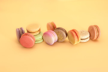 Cake french macaroons, sweet colorful macarons on yellow background