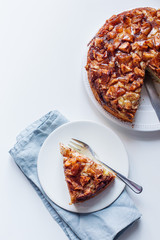 white background with a piece of apple pie on the plate