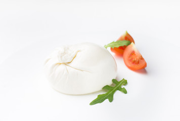 Burrata - Italian cheese, which is an excellent combination of mozzarella and cream on a white...