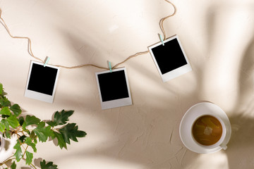 Empty photos with clothespins on a textural background. The concept of preserving memories.