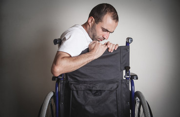 Disabled man in wheelchair in home.
