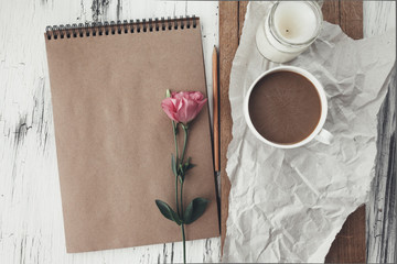 Sketchbook and coffee on wooden tray