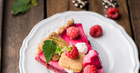 Raspberry tart with meringue on a wooden background