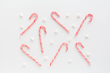 Christmas composition. lollipop canes and marshmallows on white background. new year concept. Greeting card, winter holidays, xmas celebration 2020. Flat lay, top view, copy space, mockup, template