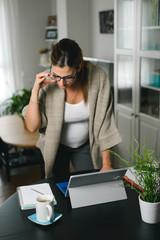 Professional pregnant woman at home