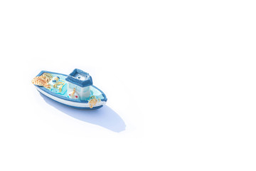 one blue miniature ship with shadow isolated on white. blue ceramic boat