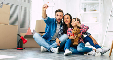Happy photo-break. A family that recently moved house and is about to start furnishing a new home...