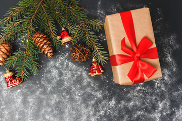 Christmas or New Year background with decorations, pine branch and gift box, top view with copy space
