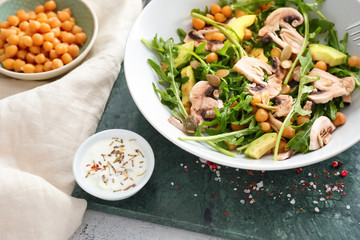 Bowl with tasty salad on table