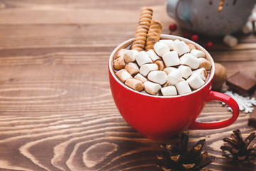 Cup of hot chocolate with marshmallows on wooden table