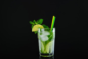Glass of tasty cocktail on dark background