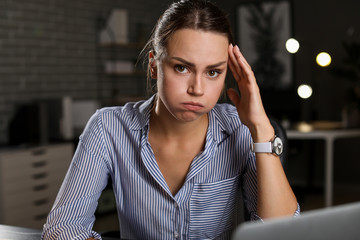 Tired businesswoman trying to meet deadline in office