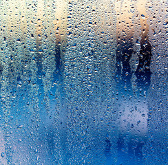 A foggy window at sunset as an abstract background