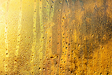 A foggy window at sunset as an abstract background