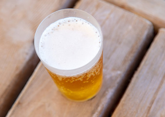 Glass with beer on a wooden background