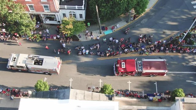 Crowds of people line the streets of parade, honor first responders, emergency personnel, fire rescue