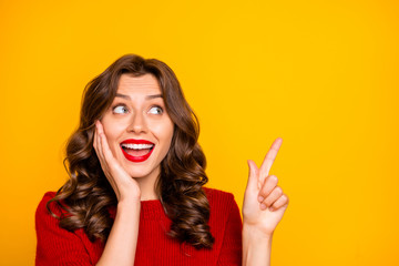 Photo of curly wavy white trendy charming cute pretty sweet girlfriend wearing red sweater pointing up astonished isolated with yellow vivid color background