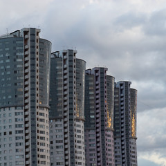 High-rise modern buildings. New apartment buildings against a cloudy sky. Urban landscape.