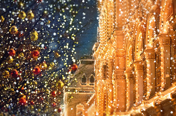 Christmas city landscape. trees with glowing garlands red and golden balls on city street, abstract...