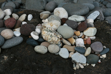 Volcanic stones on ocean shore, cold clean water, waves, Madeira island, Portugal