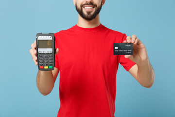 Delivery man in red workwear hold bank payment terminal to process acquire credit card payments...