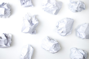 Flat lay of crumpled paper ball on white background. Top view.