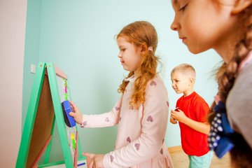 Children play and learn with magnetic board. Back to school.